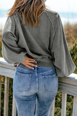 Faded gray sweatshirt with snap buttons and lantern sleeves