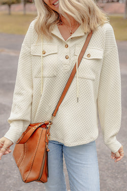 Apricot textured hoodie with button-down neckline and side pockets