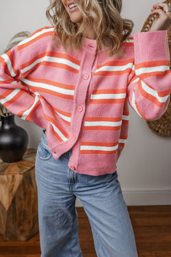 Pink striped cardigan sweater with dropped shoulders and buttons