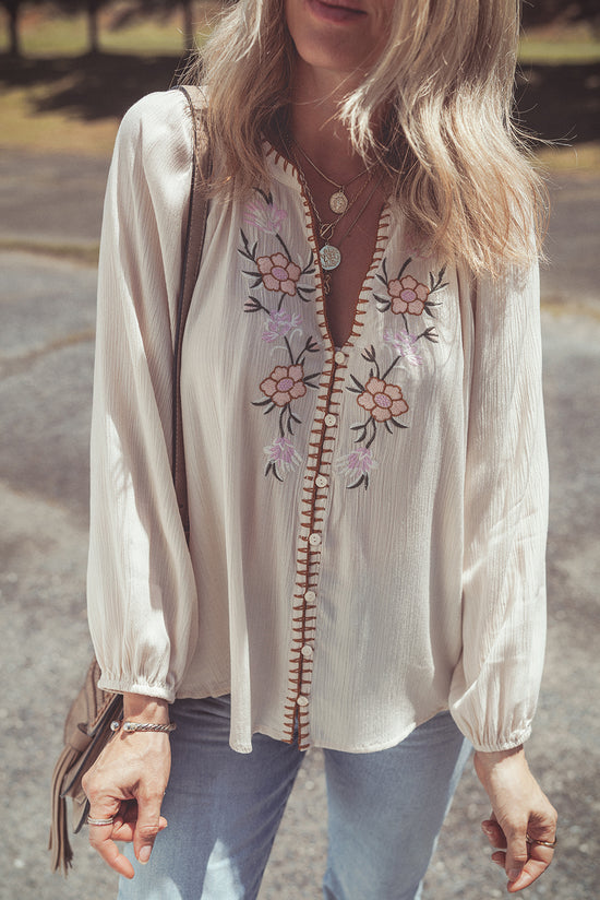 Beige loose shirt with puffy textured sleeves embroidered with flowers