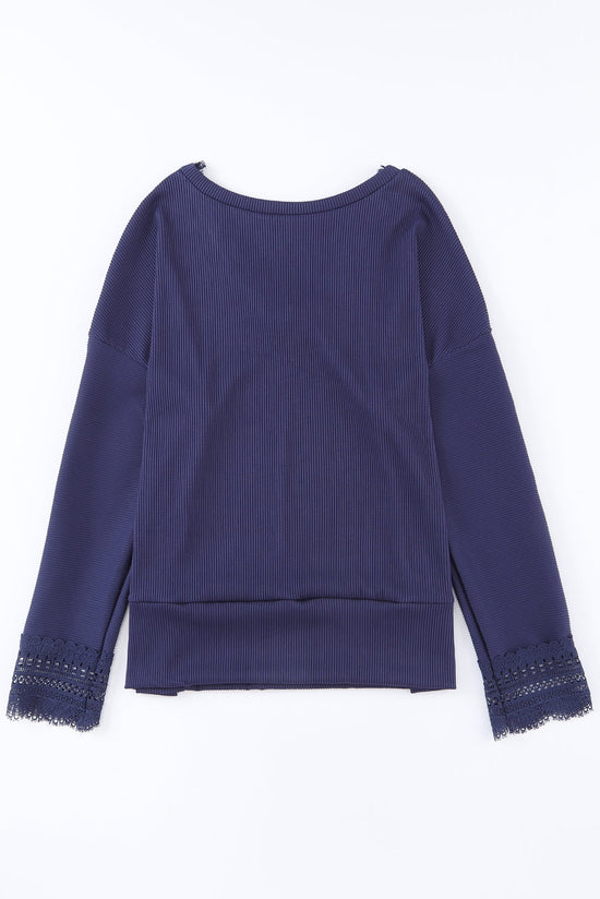 Blue long sleeve v-neck top with lace trim and ribbed texture