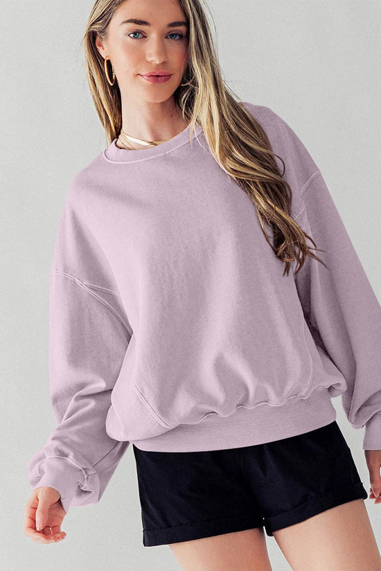 Dropped shoulder sweatshirt with batwing sleeves and exposed seams and orchid petals