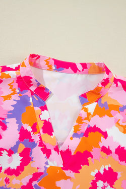 Pink blouse with abstract print and paw sleeves and notched neck