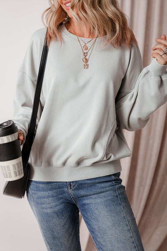 Grey sweatshirt with exposed seams, batwing sleeves and dropped shoulders