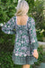 Green dress with floral print and border *