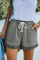 Grey high waisted denim shorts with pockets and drawstring