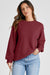 Solid burgundy sweatshirt with dropped shoulders and round neck