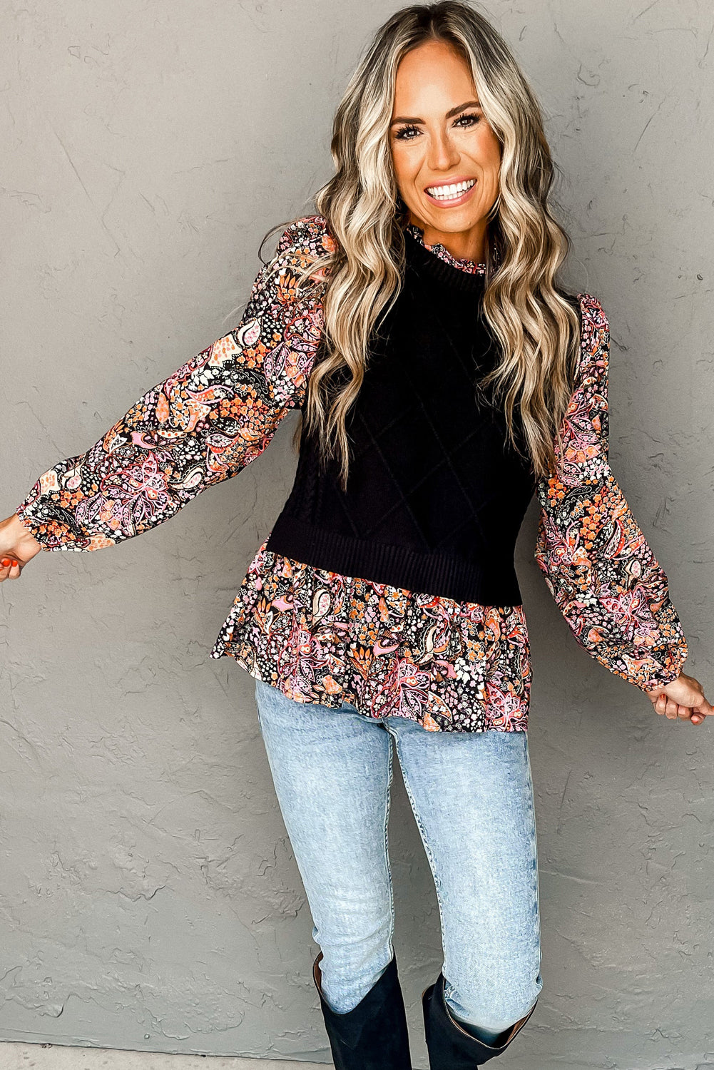 Black peplum sweater with contrasting floral sleeves