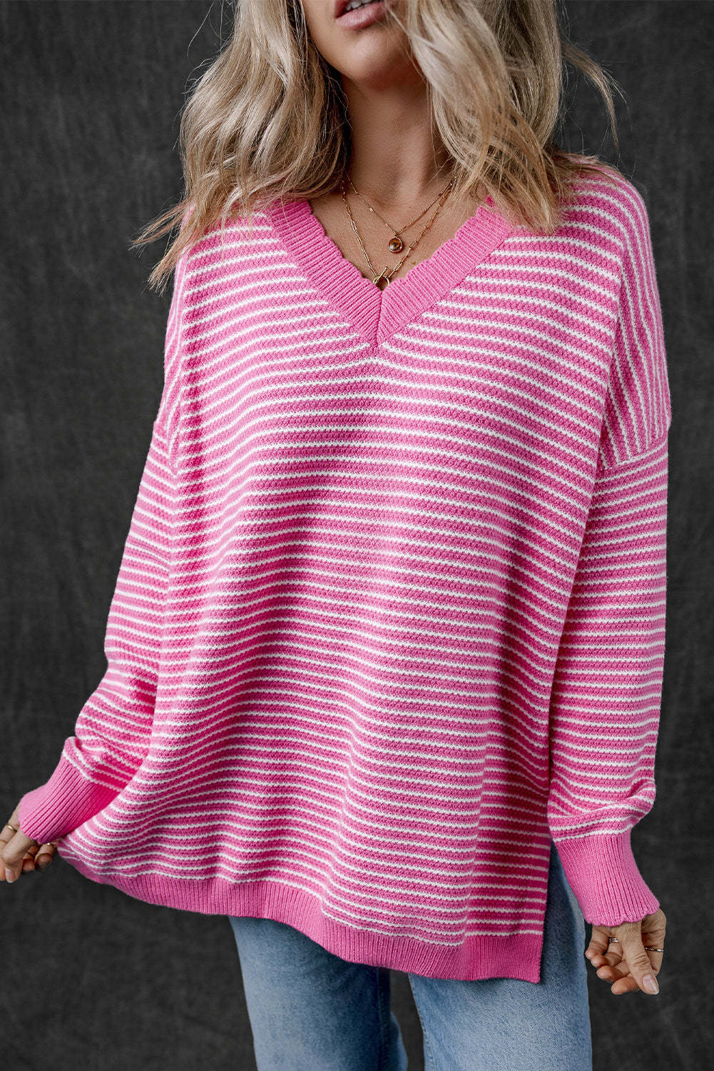 Loose V-neck sweater with pink striped slits