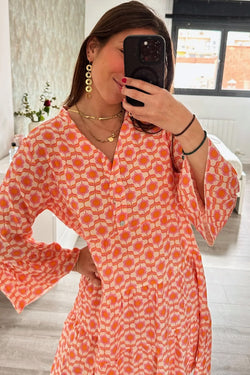 Orange floral print mini dress with ruffle sleeves and button front