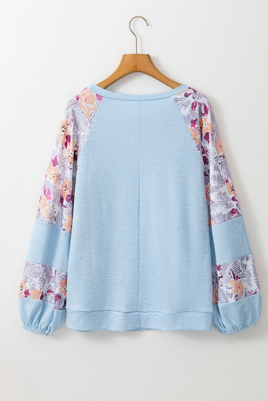 Beau Blue - Textured blouse with balloon sleeves and floral patchwork