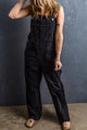 Black denim overalls with adjustable straps and multiple pockets