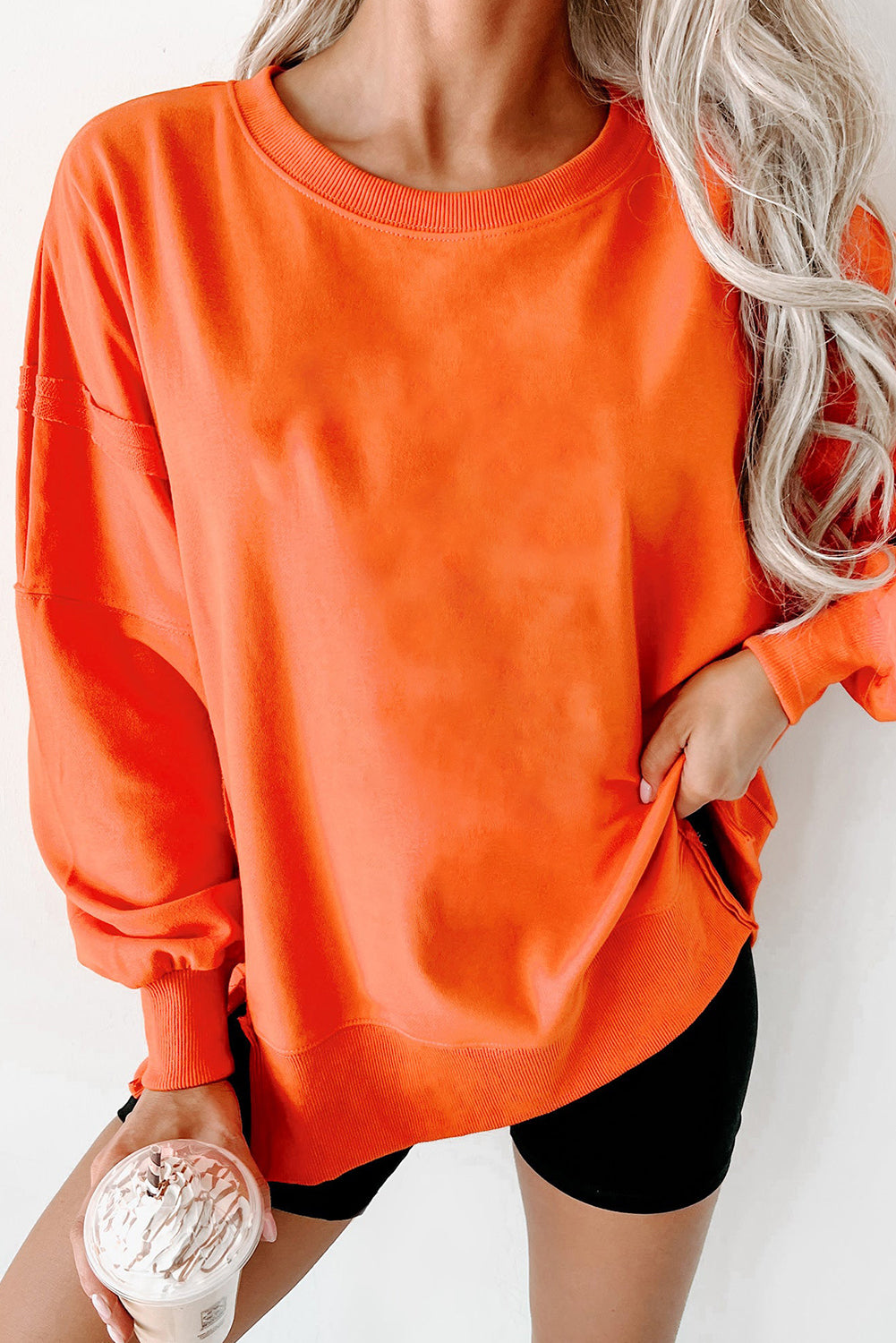 Crew neck sweatshirt with dropped shoulders and exposed seams with slits