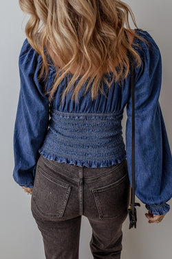 Smocked dark blue jeans blouse with ruffles and puffy sleeves in V -neck