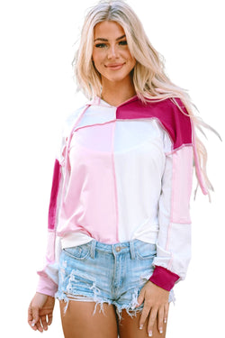 Pink hoodie with loose sleeves and exposed color block stitching