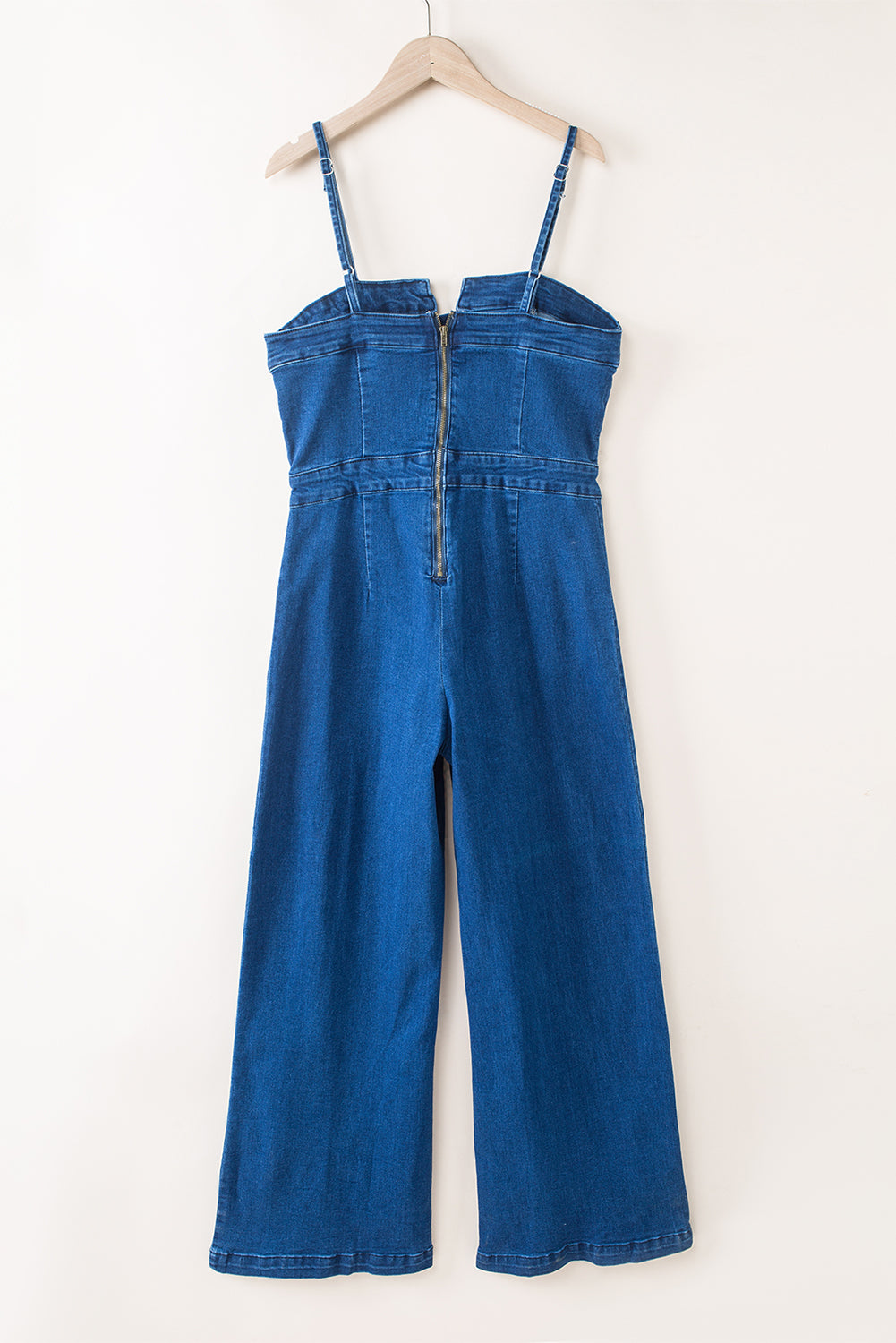 Blue denim jumpsuit with thin straps and V-notch