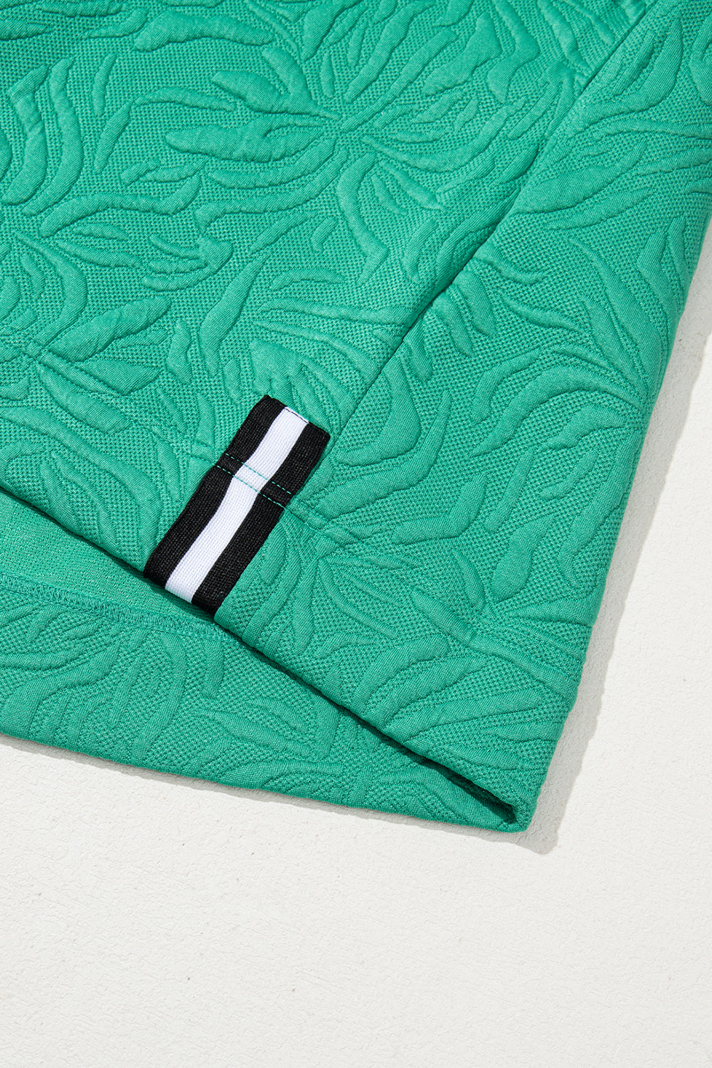 Right mini-Robe in textured jacquard with zipper on a quarter and green of water