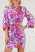 Purple floral dress with keyhole back and long sleeves with belt