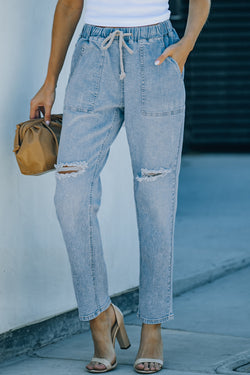 Denim jogging pants with round pockets in blue sky distress