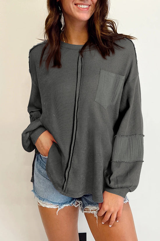 Grey waffle knit top with bubble sleeves and patchwork with exposed seams