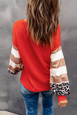 Orange top with lantern sleeves and leopard stripes