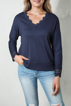 Blue long sleeve v-neck top with lace trim and ribbed texture