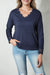 Blue long sleeve v-neck top with lace trim and ribbed texture