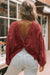 Oversize twisted sweatshirt with open back and bright red exposed seams