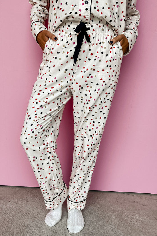 White pajama set with long sleeves and pants with contrasting and star piping