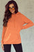 Orange hooded sweatshirt with tightening cord and kangaroo pocket with mineral washing