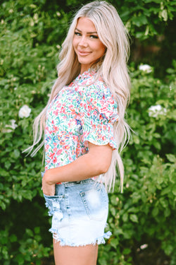 Pink blouse with floral print and buttoned, split collar, puffy sleeves