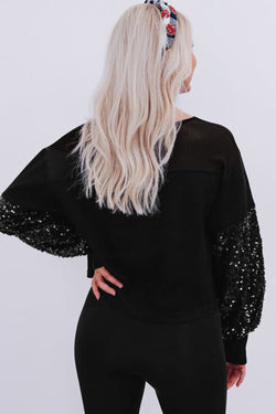 Black blouse with lantern sleeves and sequins patchwork