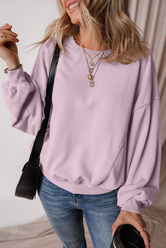 Dropped shoulder sweatshirt with batwing sleeves and exposed seams and orchid petals