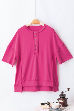 High tunic with wide sleeves and buttoned collar with apparent red pink seams