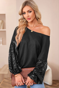 Black waffle knit top with patchwork sleeves and open back