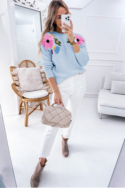 Light blue knitted sweater with ribbed edges and floral pattern