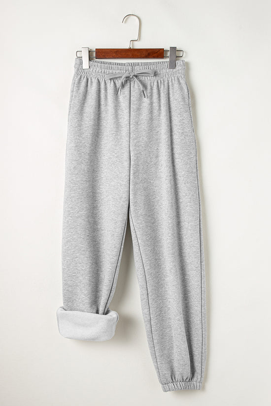 Pantalon de jogging gris clair à la taille avec cordon de serrage et doublure en polaire de couleur unie