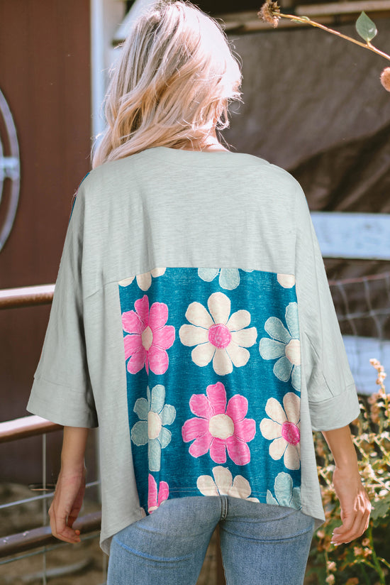 Soft -upded top with exposed seams and patchwork of green flowers