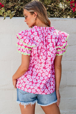 Pink blouse with crazy ricked ric superimposed sleeves contrasting with flowers