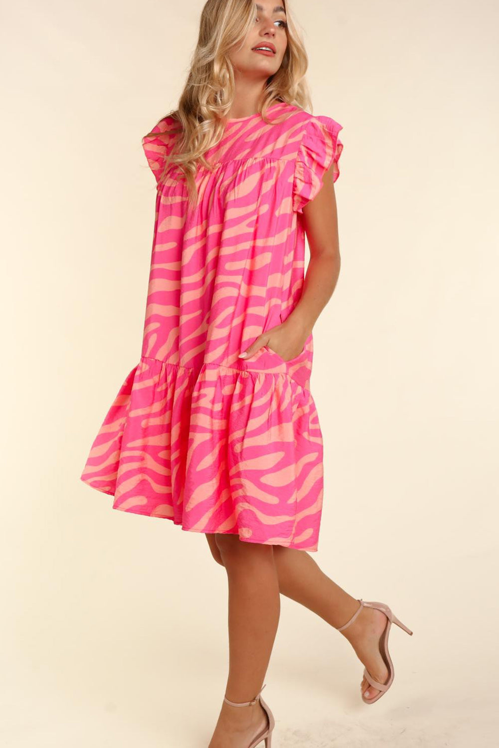 Pink dress with pockets and ruffle border printed with zero stripes