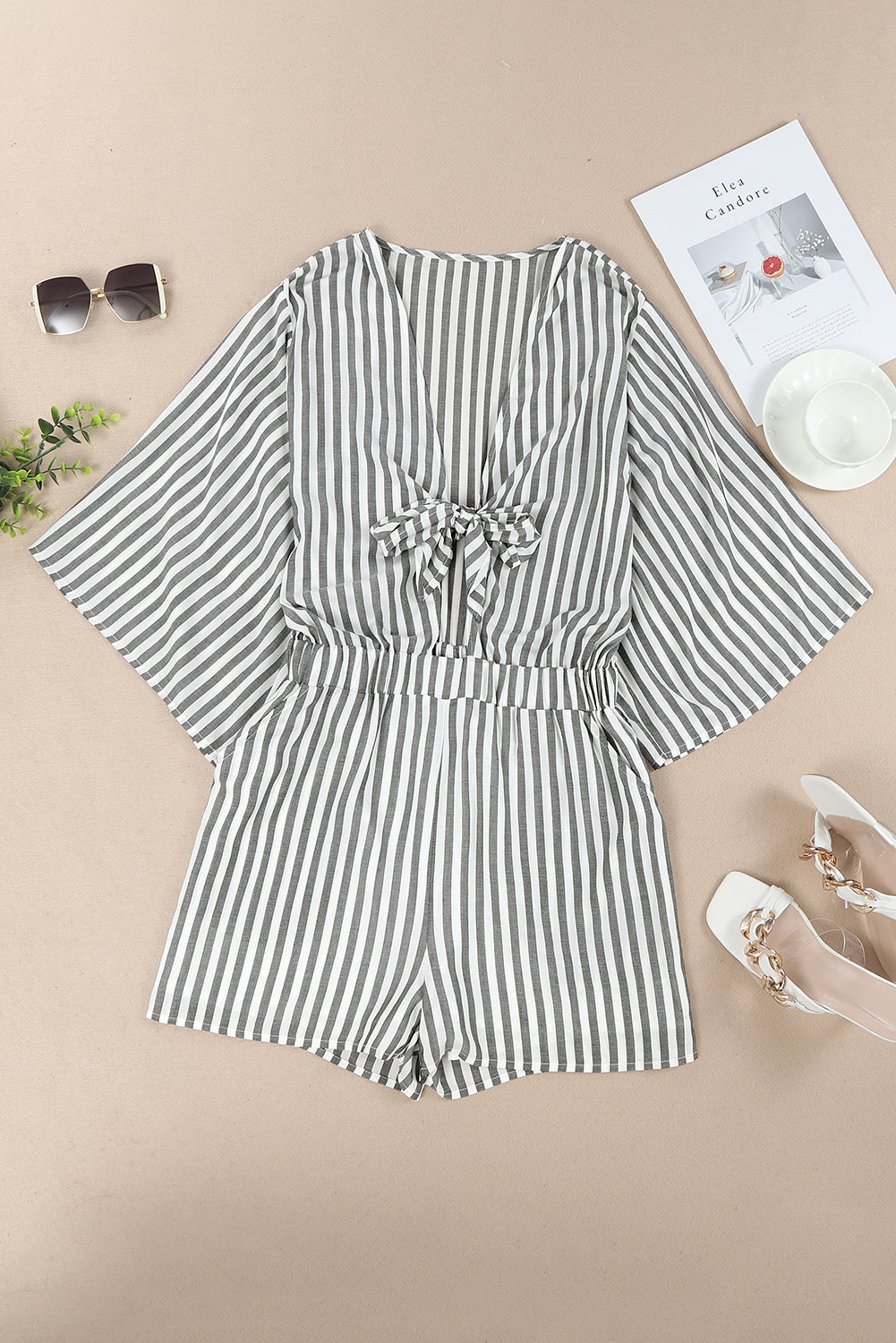 Grey striped romper with 3/4 wide sleeves and knotted front with pockets