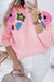 Pink knitted sweater with ribbed edges and flower pattern