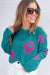 Dropped shoulder sweater in openwork knit with large sea green flower