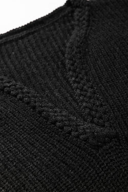 Black knitted sweater with puff sleeves and braided notched V-neckline