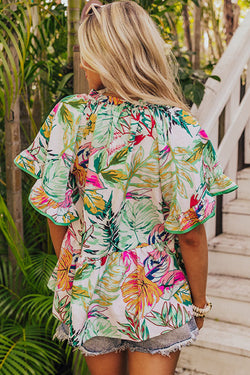 White blouse with short sleeves and ruffles with tropical floral print