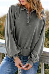 Faded gray sweatshirt with snap buttons and lantern sleeves