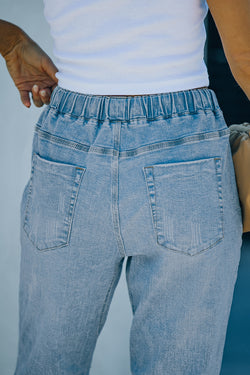 Denim jogging pants with round pockets in blue sky distress