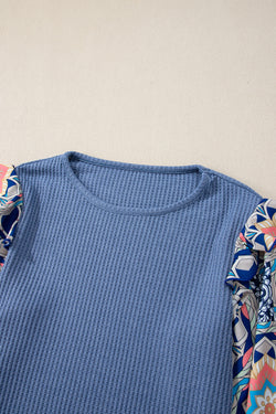 Ashleigh - Blue blouse with ruffles and floral sleeves in woven knitting with round neck