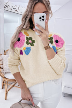 Beige knitted sweater with ribbed edges with flower pattern