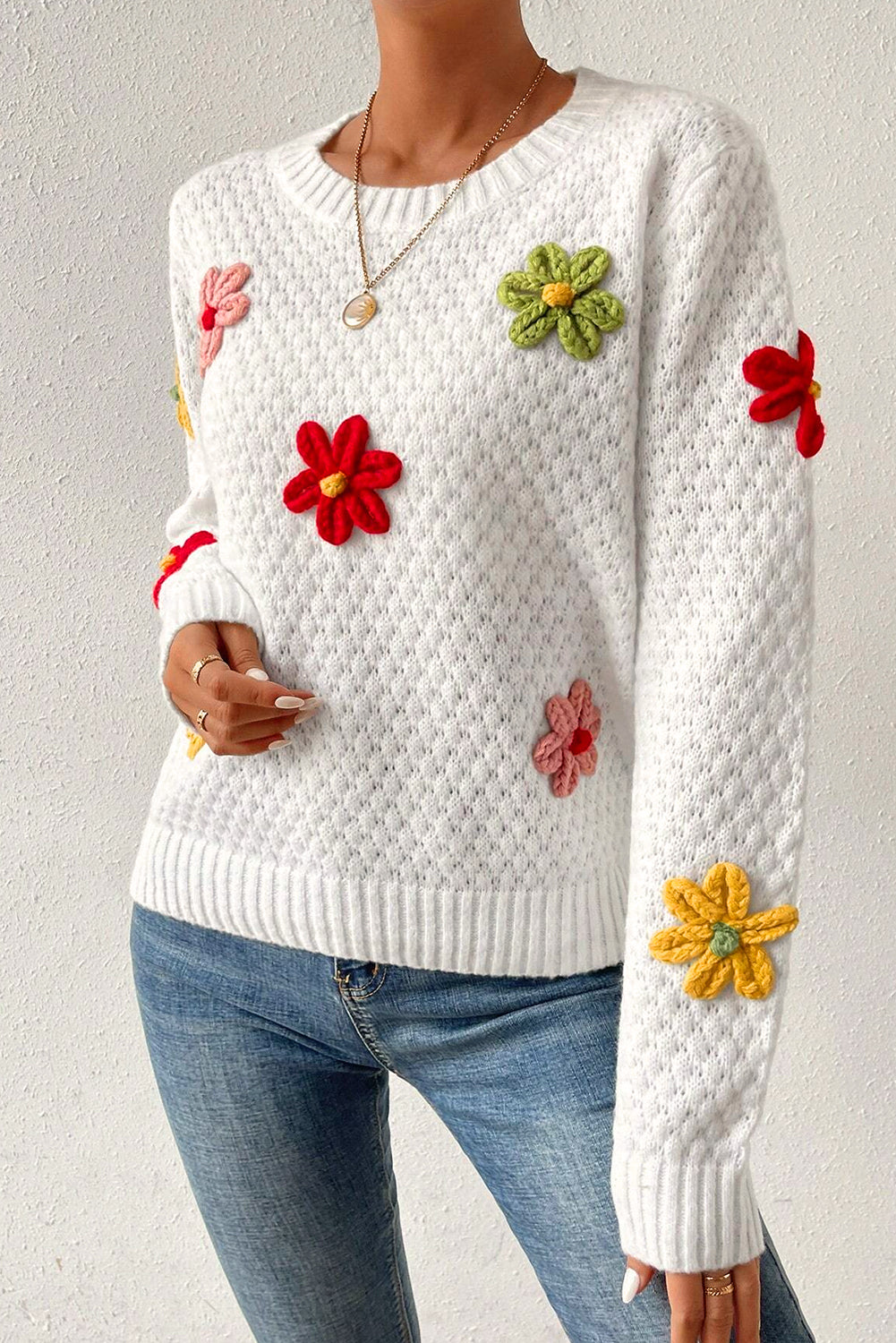 Textured knit sweater with white colorful flower appliques